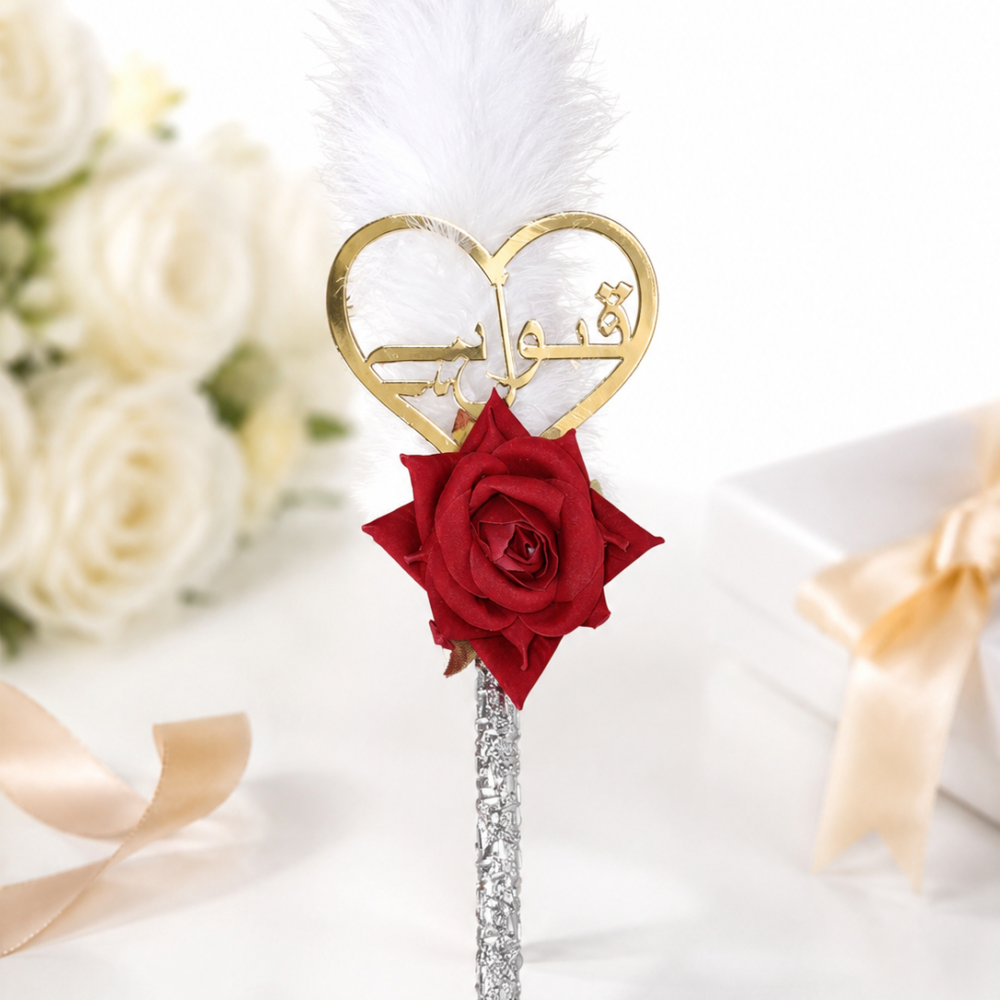 Decorative Qubool Hai Nikah Pen with a gold heart charm, red rose, white feather topper, and silver handle, perfect for Islamic wedding ceremonies, marriage signing, and bridal keepsake.