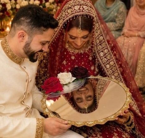 Elegant 10 inch Nikah mirror decorated with red roses and floral accents for a Muslim wedding ceremony. A beautiful bridal keepsake, wedding accessory, and thoughtful Nikah gift.